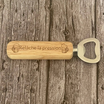 Vue de dessus du décapsuleur en bois clair gravé avec le jeu de mots sur la pression.